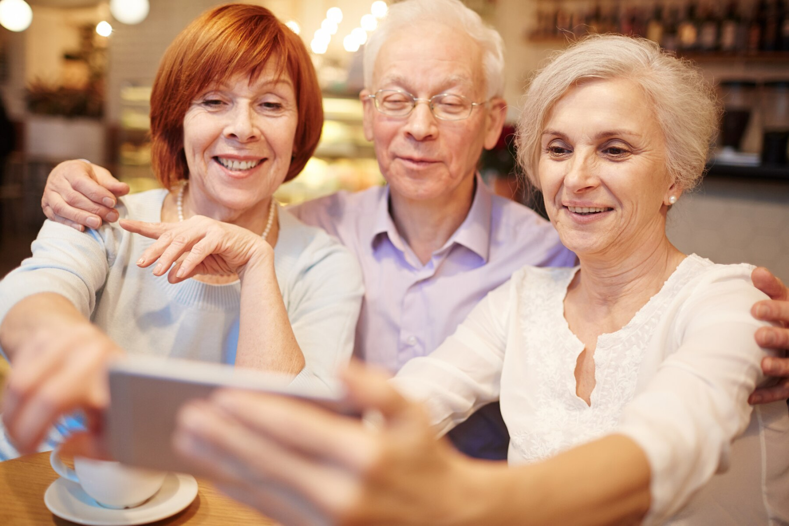 A picture of three elderly individuals taking a photo.