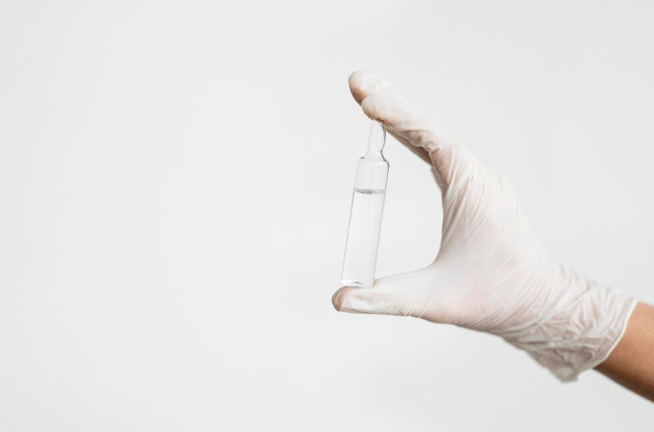 Picture of a Mobile Iv tech holding a vile. 