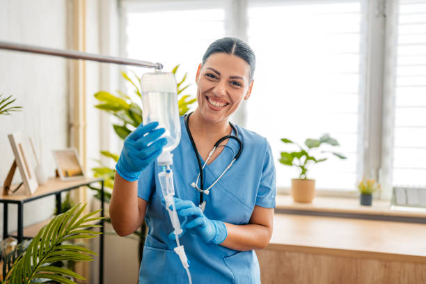A nurse prepares a vitamin-enriched saline solution for a mobile IV patient.